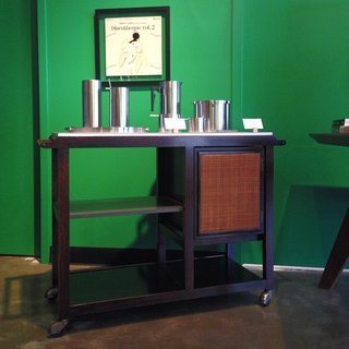 Shops We Love: Hugh - Photo 4 of 4 - A Dunbar bar cart by Edward Wormley is one of Posch's noteworthy pieces. "Even though there are new items in the store that certainly merit mention, it does seem that the vintage items we get are generally the most exceptional," he says. "The cart has a white laminate top that folds open for extra work surface, the middle shelf is grey laminate and the bottom shelf is black; and it has a storage compartment with caned doors. It's a stellar piece."