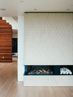 A Home with Eclectic Style Looks Just Right - Photo 9 of 19 - Tiles from Heath Ceramics surround the Ortal Clear 130LS fireplace. The white ceramic logs are by Klein Reid; the floor is oak.