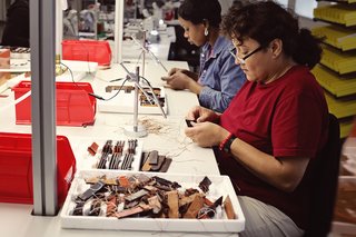 A single watch band passes through the hands of nearly a dozen people during the manufacturing process.