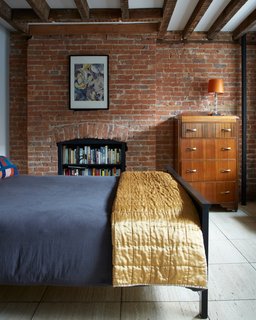 25 Homes With Exposed Beams: Rustic to Modern - Photo 22 of 25 - The travertine floor for the guest bedroom came from a De La Espada showroom in Soho. When moving stores, the owners were considering throwing out their travertine floor, but Dealtry offered to install it in his home. Along with exposed ceiling beams, the tiles provide a sense of texture and warmth to the space. 
