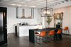 If you’re able to dish out a significant sum on a renovation, pinpointing the areas of the home to tackle can be frustrating. Berkus warns that opting for trendy construction materials is not the way to go. “I am always interested in learning what’s happening with advancements in technology, but regardless of how much money you have it is always best to air on the side of timeless and classic in terms of construction materials,” Berkus says. “You can still live in a very modern way using classic materials like subway tile, statutory or Calgary white marble, stainless steel or butcher block countertops.”
Pictured is a dining room and kitchen renovation designed by Machnik in a Los Angeles loft for American Dream Builders. Photo courtesy NBC. Photo of Renovation Tips from American Dream Builders' Nate Berkus modern home