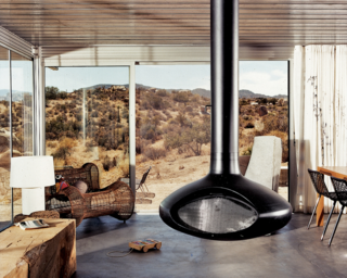 A view from the interior of the "iT House" , the home is more a watchtower for the desert scenery. The large expanses of operable sliding glass doors offer plenty of cross-ventilation and the cool concrete floors provide ample thermal mass. 