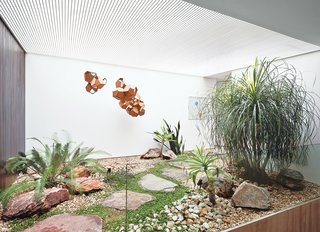 A small interior courtyard features a huge skylight and the sculpture Air-Port-City/Cloud-City/ 14-5-4 Cloud Modules 30 Net by Tomás Saraceno.