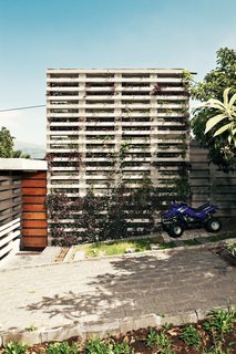 An Innovative Modular Building System in Ecuador - Photo 1 of 10 - "Your first impression is that the house is very closed," says David Barragán of the building he designed with Jose María Sáez in Quito, Ecuador. Stacked concrete forms, developed by Barragán and Sáez and used as planters along the front facade, offer privacy and integrate the building with the site.