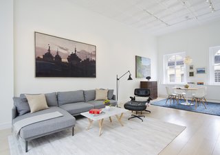 Eames Lounge Chair Porn - Photo 8 of 53 - The living area now feels open and bright and showcases the couple’s appreciation for furniture design and artwork. The family opted for a Camber sectional and rug from Design Within Reach, coffee table from Steven Alan Home, and replica Eames Lounge to outfit the space.