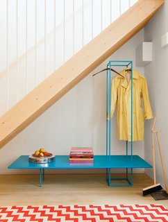 They’ve stocked it with custom furniture like the blue bench storage rack.