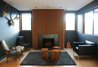 You Won't Be Calling This House a "Man Cave" - Photo 2 of 9 - A series of Douglas fir slats was applied above the fireplace.