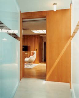 Lloyd-Butler’s second-floor office in the old house, which connects to the addition via the frosted-glass bridge.