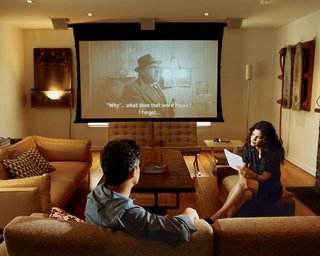 Hachigian and Day in the living room/screening room, which opens onto a terrace above a reconstructed garage. The living-room table with a resin-and-acrylic top was designed by Hachigian’s brother, Garo.