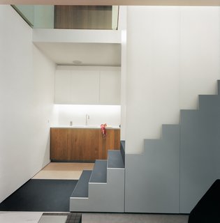 The staircase acts as both room divider and main storage. The stair "carpet" is made from the same tough rubber that is used to make tires for semis.