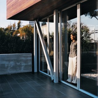 Maricarmen looks out toward the ocean from inside the sliding glass NanaWall.