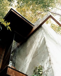 This detail shows the conjunction of concrete with wooden beams, where flush glass windows angle outward to the canopies of nearby trees. The detail also encapsulates Ray's vision for the house: a synthesis of the rational and the intuitive.