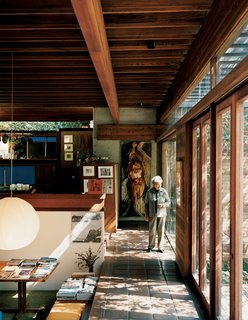 Shelly walks along the perimeter of the house, near the central living area. The design of the house, with its many rooms, nooks, and open family spaces, "was so ahead of its time," Shelly says, "that, to young people coming here, it still feels contemporary."