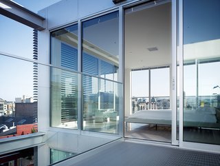The master bedroom opens to a private courtyard and illustrates Saitowitz's vision for open space and ample cross breezes. "Typically all lofts and apartment units are quite deep, and they just have light coming in from one direction," says Saitowitz of his plan for 1234 Howard. "So here, they basically have light along their long dimension."