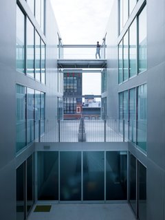 The central open space at 1234 Howard is traversed by footbridges and shared courtyards.
