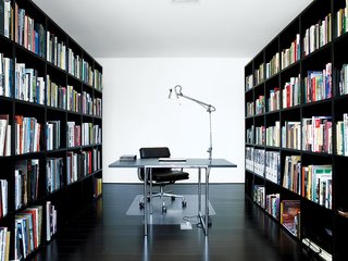 The library is formed simply by two custom bookcases enclosing the space.