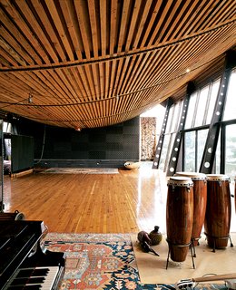 Adjacent to the owner’s larger home, the Music Studio, with its bowed, ship-like ceiling, was designed to house events, parties, and performances.