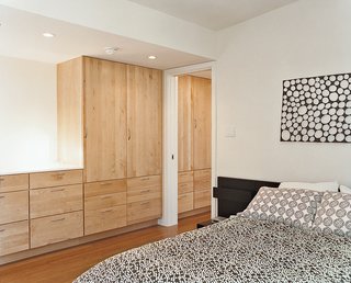 In the bedroom, a hanging mobile by Oras over the headboard makes a big difference.