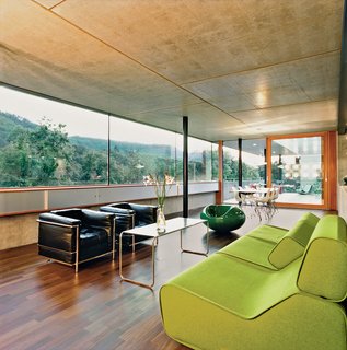 After walking through the front door visitors enter directly into the enormous kitchen and living space. The interior is minimal, using predominantly timber and concrete. It also provides some spectacular views of the river.