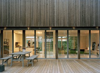 The spruce panels that coat the second-floor exterior will fade in tandem with the zinc-coated steel that rims the glazed windows and doors. "They will go gray like we do," says Claesson.