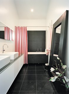 The master bathroom is one of few spaces that lacks windows, but it opens onto the brilliantly daylit master bedroom.