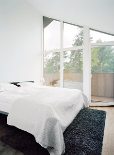 Triangular windows beneath the roof line are a common element in all of the second-floor rooms, including the master bedroom.
