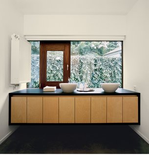 The bathroom mirrors the same materials, colors, and design principles as the rest of the building.