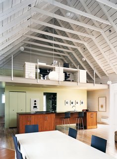 The office space above the kitchen looks out onto the great room.