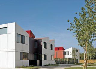 Rogers Stirk Harbour & Partners have made a feature of the roof-mounted EcoHat, which both hides unsightly solar panels and gives a unique look to the properties.