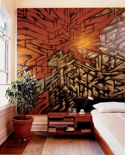 Bay Wash - Photo 7 of 9 - Azevedo made the platform bed and side table in her master bedroom, and bartered furniture for the mural by artist friend Mike Stern.
