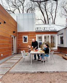 Out back, the paved patio serves as the family's main dining room. Though occasionally snow and cold keep them inside, family dinners can often be enjoyed outdoors.