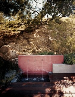 An outdoor water feature adds a subtle soundtrack to the property while keeping the plants irrigated.