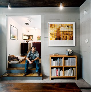 Salvage Love - Photo 2 of 10 - Dollahite perches on the steps to his living room beside his dog, who saw him through the entire renovation.