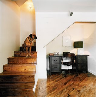 Salvage Love - Photo 5 of 10 - From the stairs West looks across the living room over the salvaged pine floors, which run throughout the house.