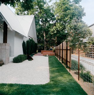 Salvage Love - Photo 10 of 10 - Patches of sod amid white gravel keep water needs low.