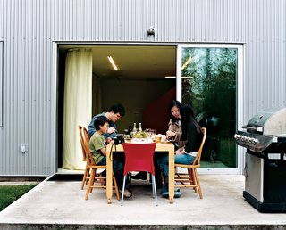 The Wibowo family spends most of their time together on the first floor. "We're always here, cooking or with the kids," Wibowo explains. "On a nice day, we open up the doors and eat outside."