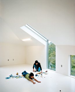 To add extra illumination to the third floor loft, Wibowo placed Dan Flavinesque sculptural (and inexpensive) four-foot-long fluorescent tubes into the slanted ceiling.