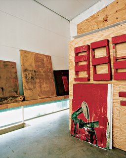In the studio, Kyle Farley's paintings lean against the walls and lie across the floor in various stages of progress.