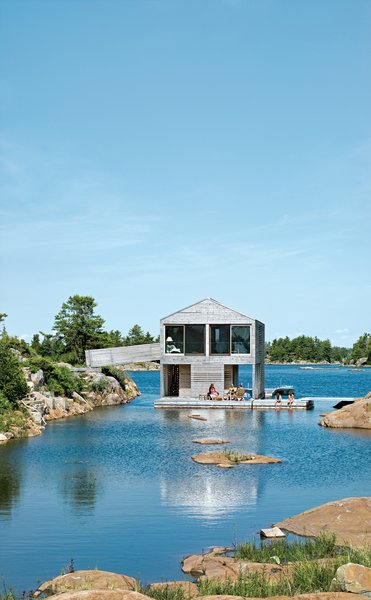 10 Modern Floating Homes That Offer an Aquatic Lifestyle - Photo 2 of 10 - Cedar slats mark the facade of the Worple's lakefront vacation home in Ontario.