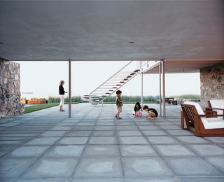 Until Sasseen took ownership, the ground at the back of the house was sheathed in concrete. She created a softer environment when she replaced it with bluestone and planted beach grass that rustles in the ocean breeze.