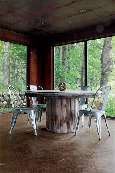 10 Enclosed Porches That Are Put to Good Use - Photo 5 of 10 - "Repurpose, refurbish, recycle" was the guiding principle for a metals broker in Ontario who harnessed his passion for–and knowledge of–industrial materials to create a new house from old scrap. Shown here is the enclosed porch.