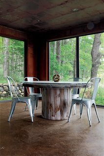 "Repurpose, refurbish, recycle" was the guiding principle for a metals broker in Ontario who harnessed his passion for–and knowledge of–industrial materials to create a new house from old scrap. Shown here is the enclosed porch.