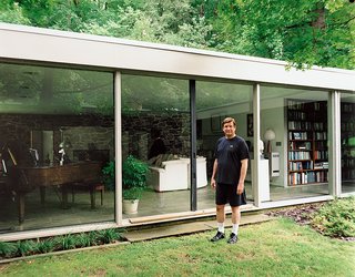 North stands outside his glass-walled living room, which also houses his small library of books about Breuer.