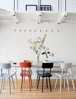 Piet Hein Eek's wooden chairs add a touch of color to the monochromatic apartment. "I'm a fan of simple modern furniture, with a twist," says Carr. "I wanted to buy everything from Piet Hein Eek."