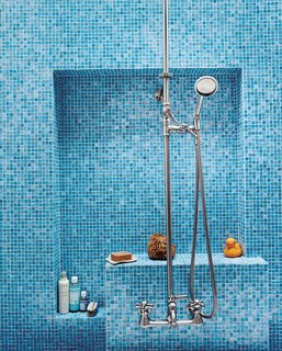 The bathroom glows with various shades of Turkish-style glass tiles (in Iris) from Galleria Tile in San Francisco; the custom nickel-plated hardware is from Chicago Faucets.