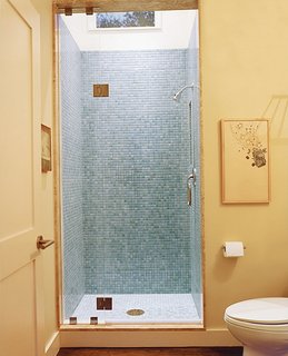 The office adjoins a light-filled guest bathroom.