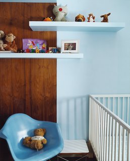 Their son's bedroom features skillful use of ordinary birch-finished shelves from Ikea. The 1950s fiberglass shell chair is from Modernica.