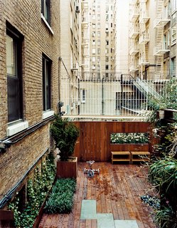 The Zizmors installed a 16-foot-wide deck for playing and grilling, and lined it with hostas, Hollywood juniper, and bamboo.