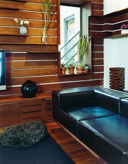 Ingenuity can compensate for a modest budget. The Zizmors removed the base from a mid-priced leather couch from West Elm and inserted it in a custom armature made with walnut veneer.