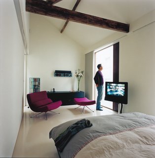 The couple still prefers CDs to the more space-efficient MP3s, though a retro Plexiglas car-ousel nicely complements their Bang and Olufsen multiple CD player, showing off their favor-ite selections. Floor-to-ceiling windows in the upstairs bedroom bring a vast amount of light in, making the bedroom seem far more spacious than it actually is.